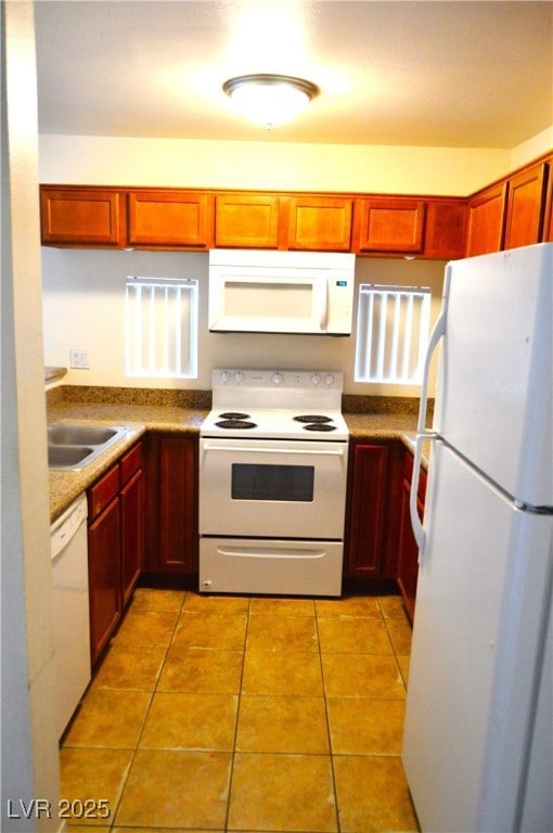 Kitchen featuring white appliances, light tile pat