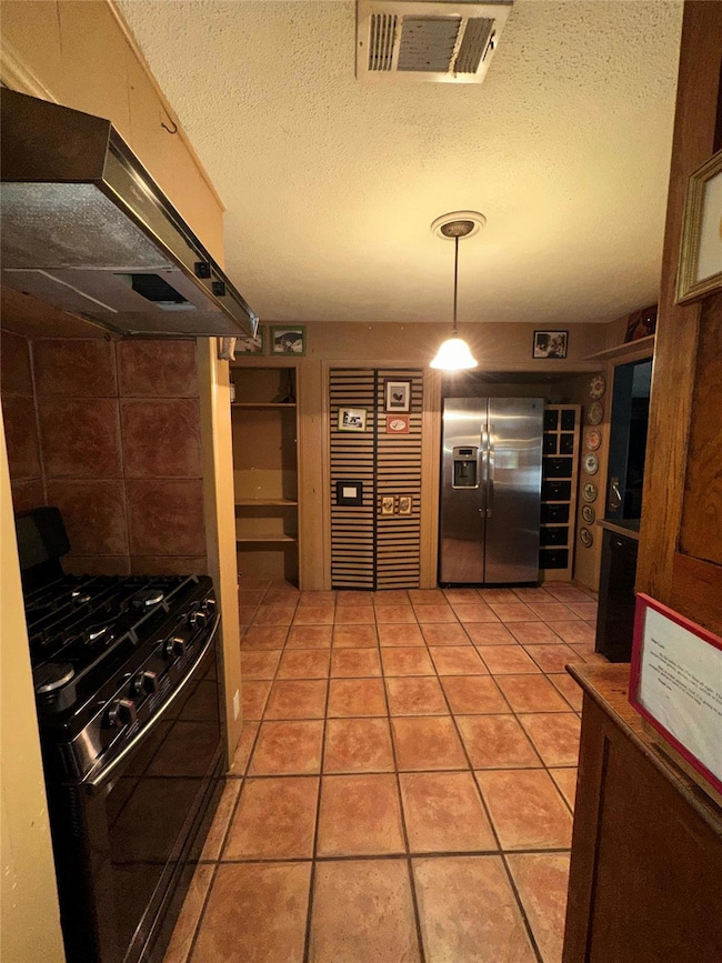 Kitchen featuring stainless steel fridge with ice 