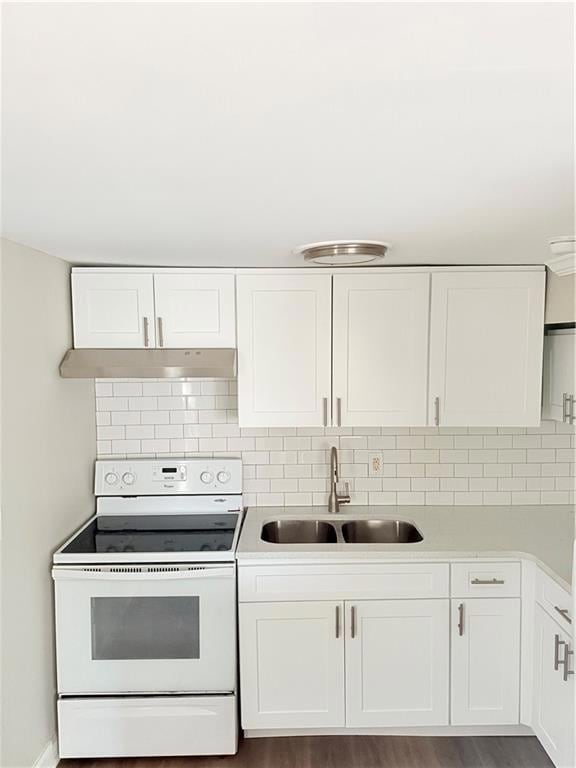 Kitchen with a sink, decorative backsplash, range,