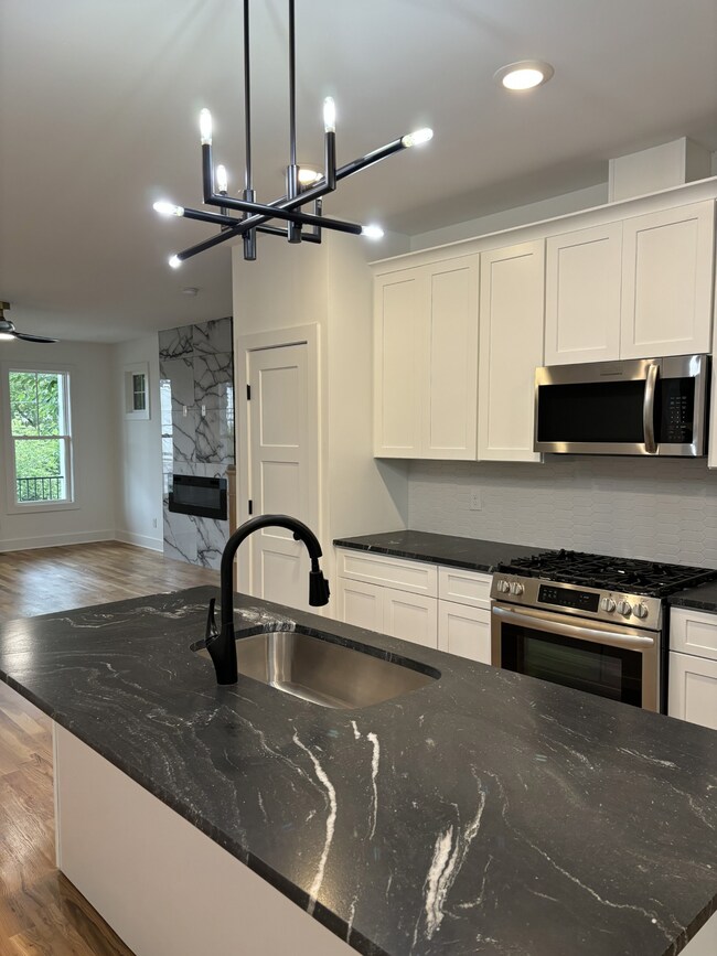 Open Kitchen with nice leather granite countertops and stainless-steel appliances.