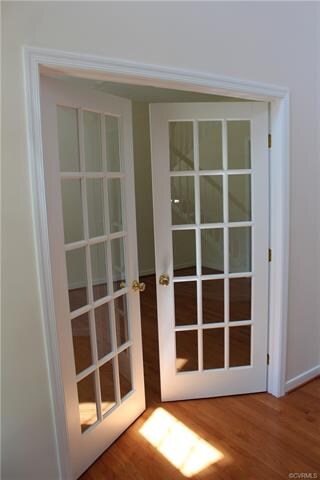 The foyer French doors lead to the formal living r