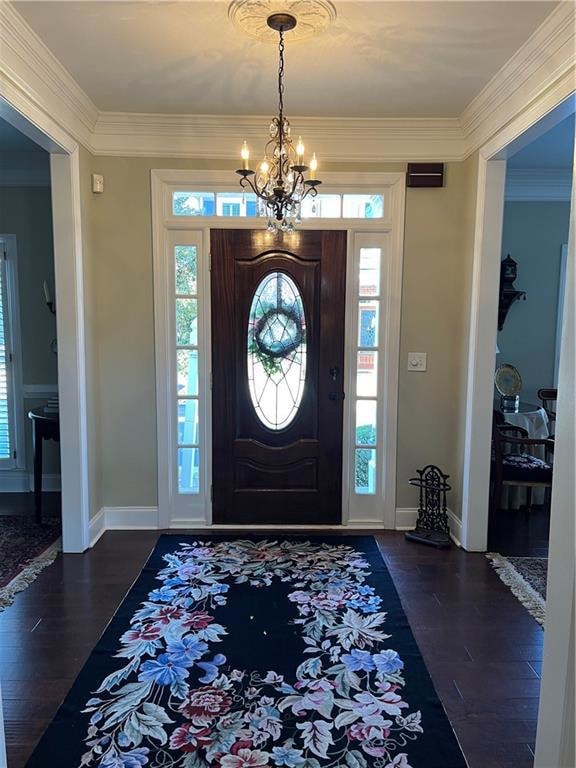 Foyer entrance featuring classic chandelier, wood 