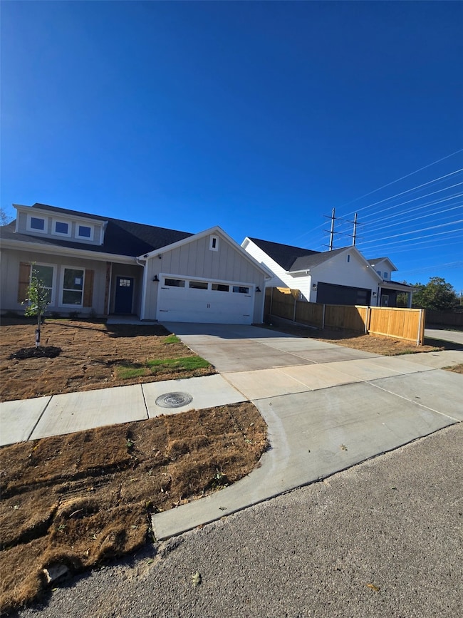 View of front of property featuring concrete driveway, board and batten siding, a garage, and a porch