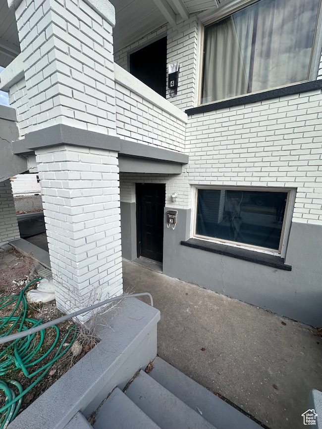 View of exterior entry with a fireplace