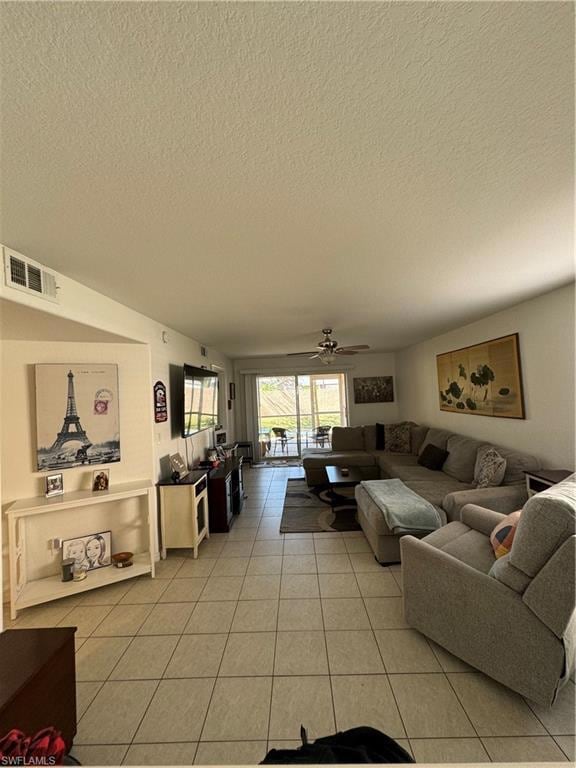 Living room with light tile patterned floors, a te
