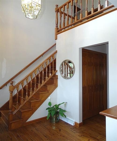 Open staircase with nice view of the upper level loft.  Notice the beautifully stained woodwork throughout!