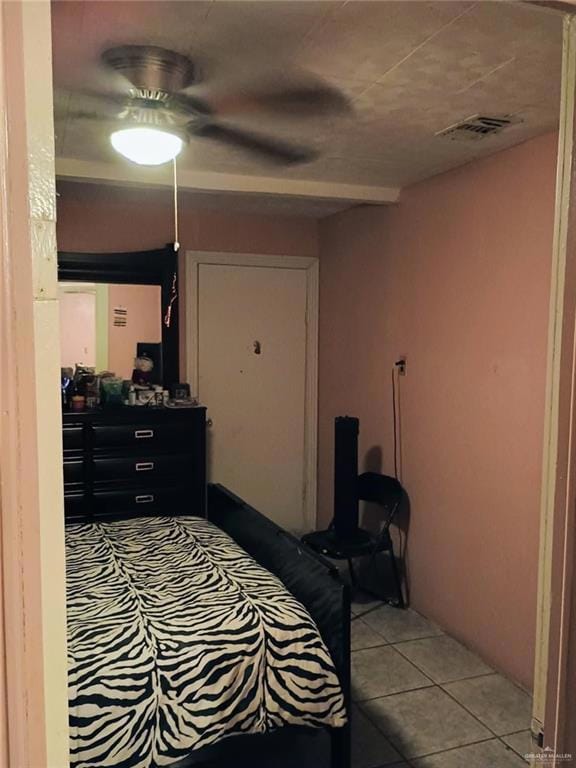 Bedroom featuring light tile patterned floors and a ceiling fan