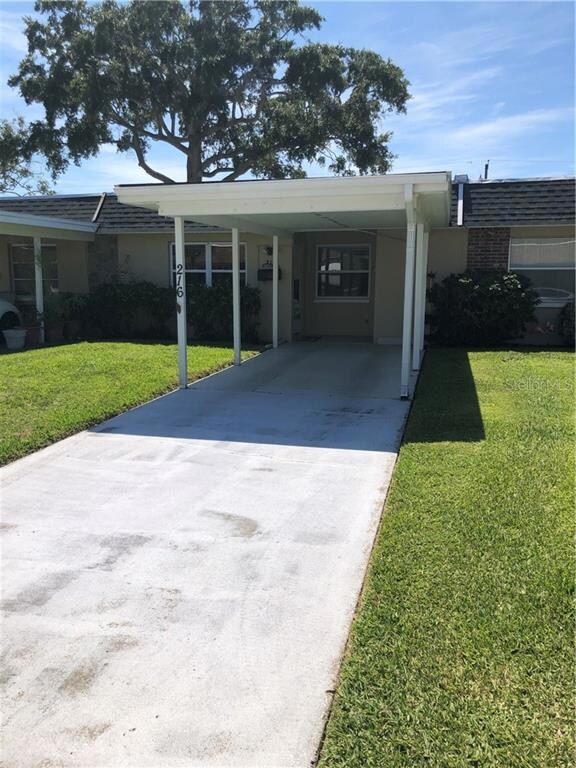 The carport can fit one car and the drive way another.