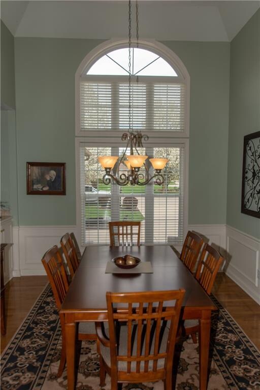 LIGHT AND BRIGHT FORMAL DINING ROOM WITH HARDWOOD FLOORS AND TRAY CEILING