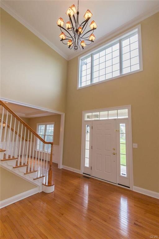 Impressive two story foyer with crown molding and 