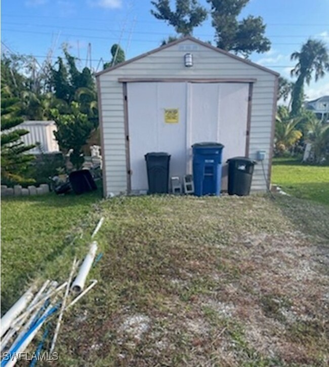 View of outdoor structure with a yard