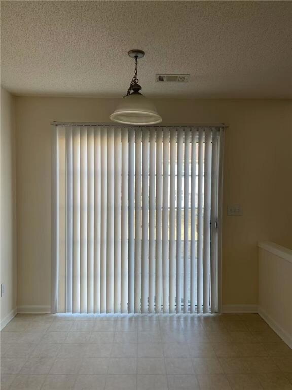 Empty room featuring a textured ceiling