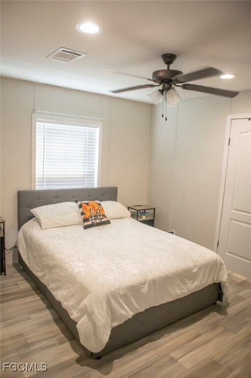 Bedroom featuring recessed lighting, wood finished floors, and ceiling fan