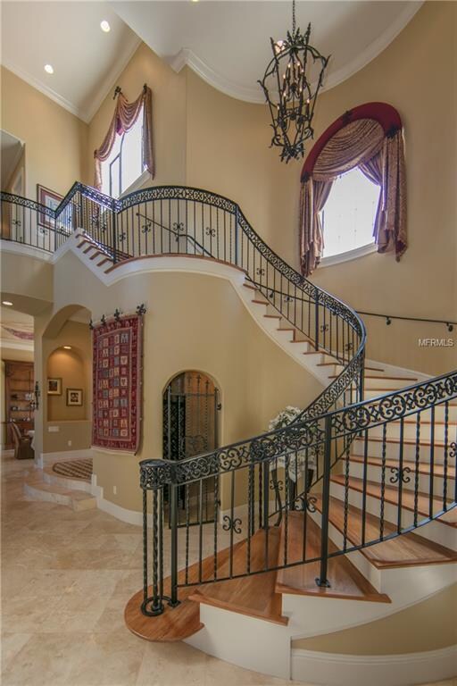 Sweeping staircase leading up to three additional 