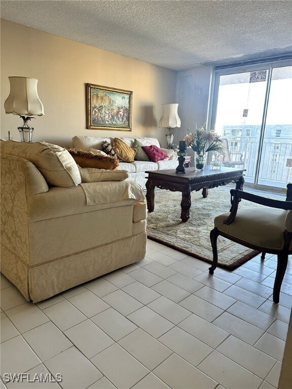 Living room with floor to ceiling windows and a te