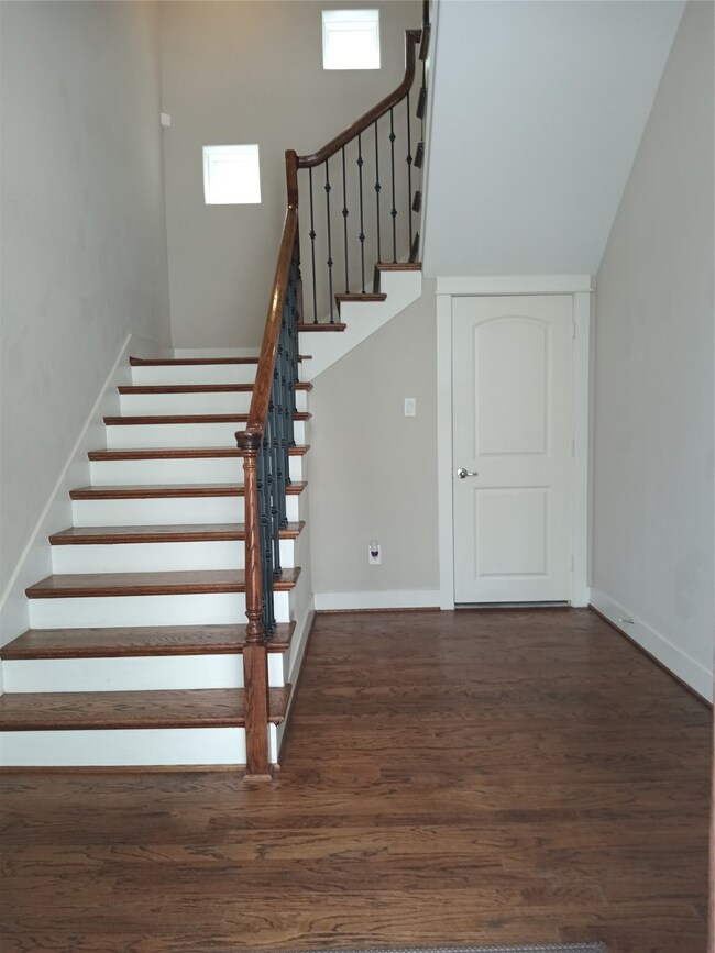 Open the front door into the foyer with hardwood f