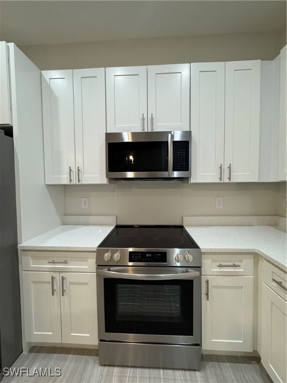 Kitchen with stainless steel microwave, range, fri
