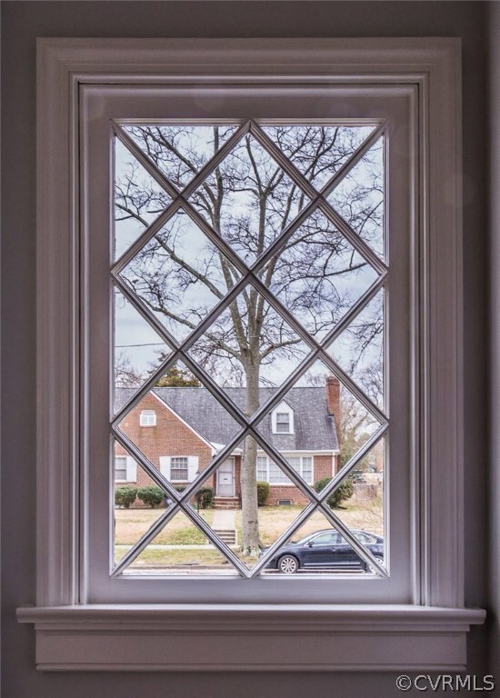 Charming Tudor style windows flank the fireplace in the living room.
