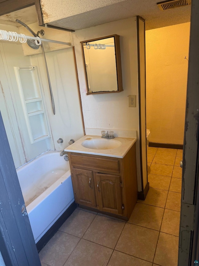 Full bathroom with vanity, tile patterned flooring