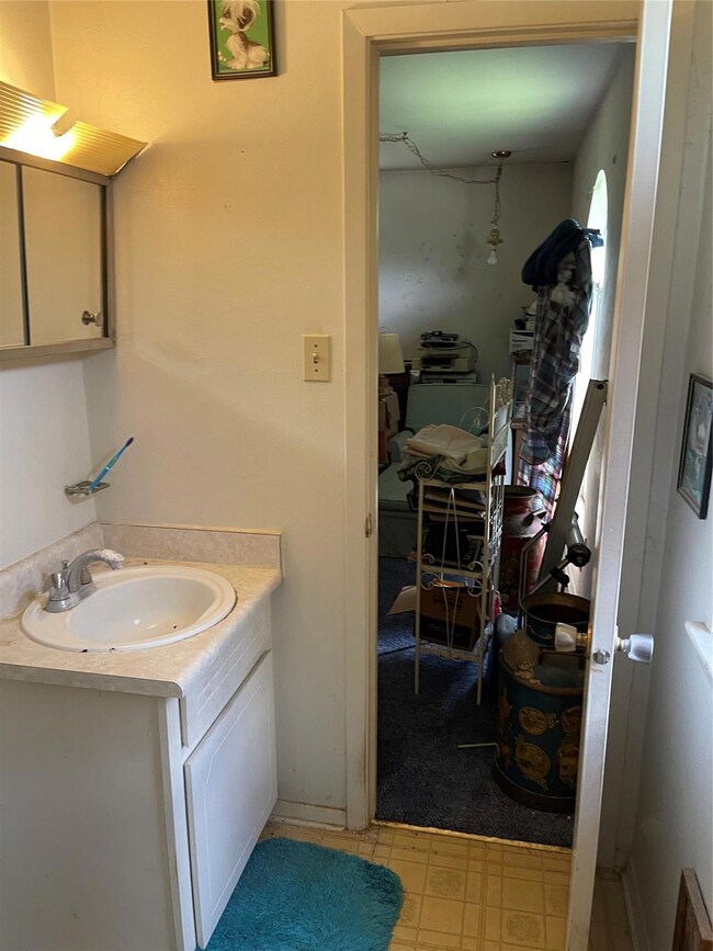 Toilet and vanity in primary bedroom that opens up