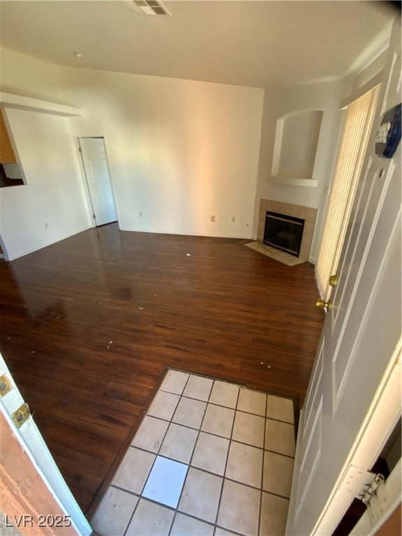 Unfurnished living room featuring visible vents, w