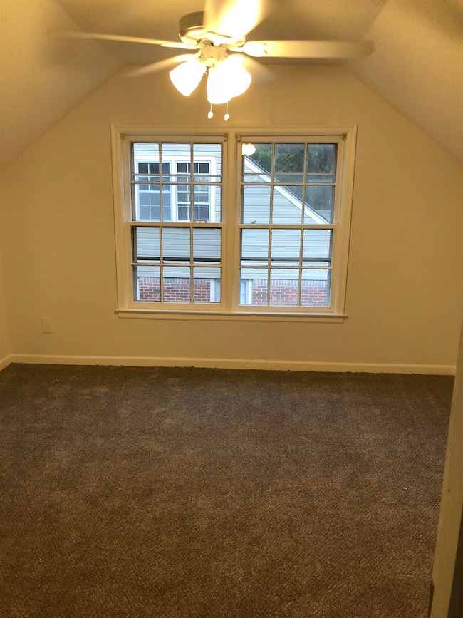 Bonus room featuring dark colored carpet, ceiling 