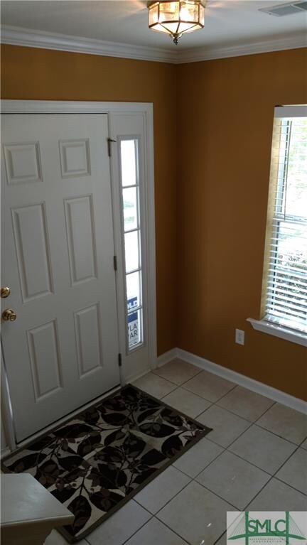 Bright foyer entry with tile floor