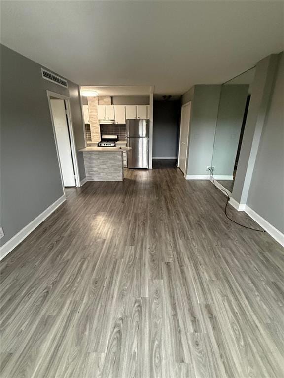 Unfurnished living room with dark wood finished floors
