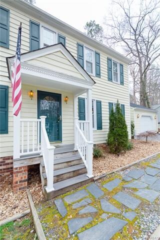 Slate pavers lead to a covered stoop.