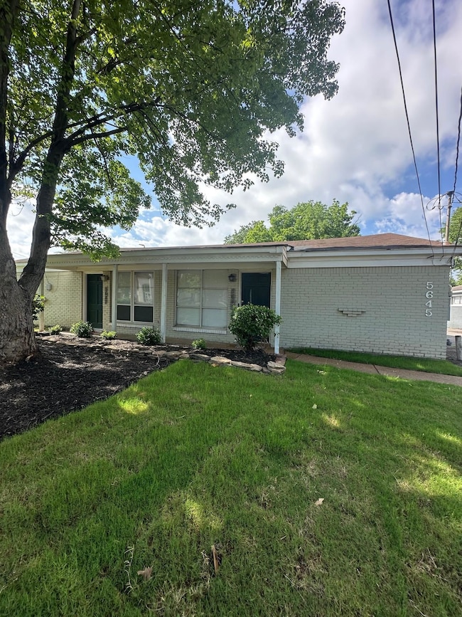 View of front of house featuring brick siding and a front lawn
