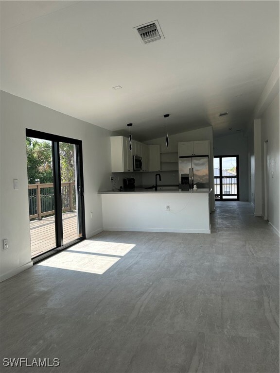Unfurnished living room with concrete floors, visi