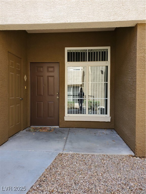 Entrance to property featuring stucco siding