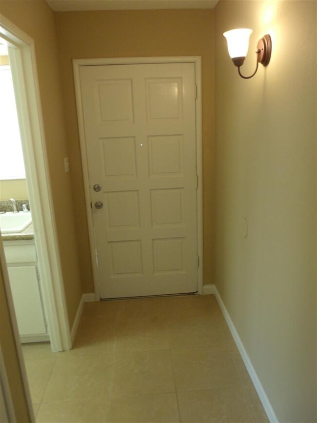 Entry foyer from inside with kitchen to left.
