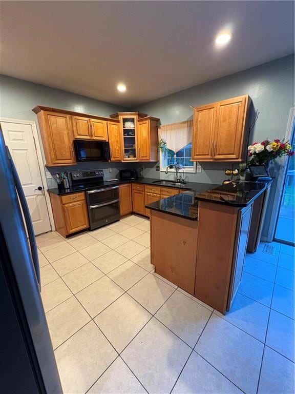 Kitchen with stove, a peninsula, brown cabinets, l