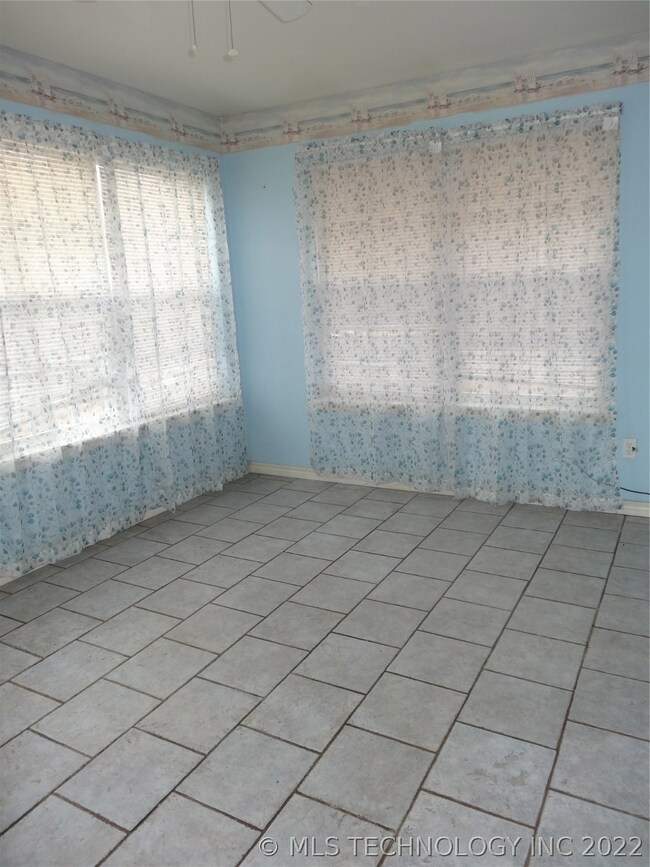 Sun Room/Hobby room has windows all around and til