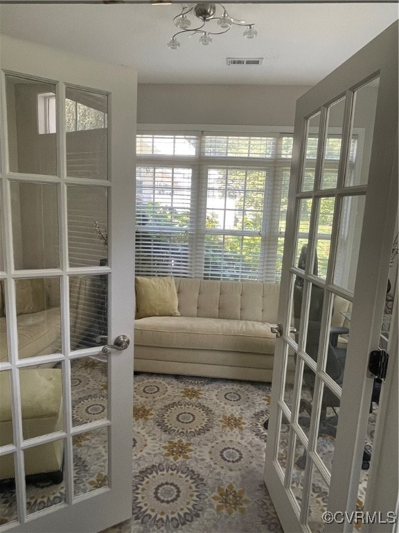 Sunroom / solarium featuring french doors