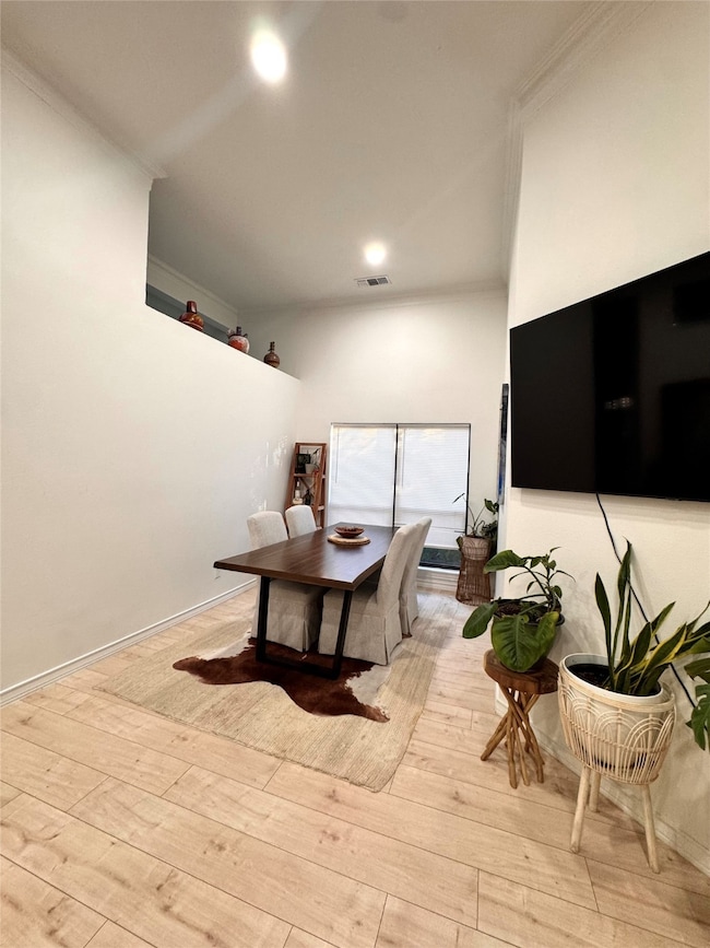 Dining area featuring light wood-style flooring and baseboards