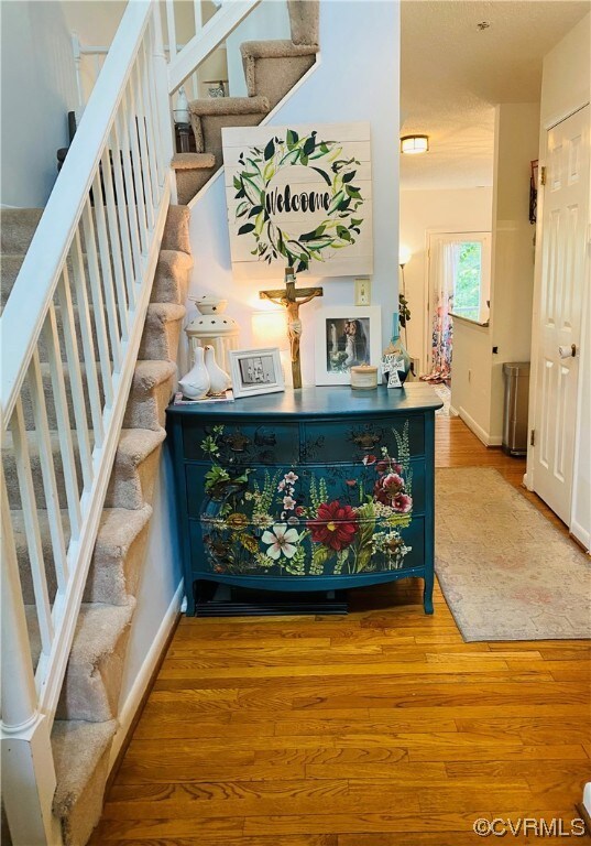 Foyer entrance with hardwood flooring.