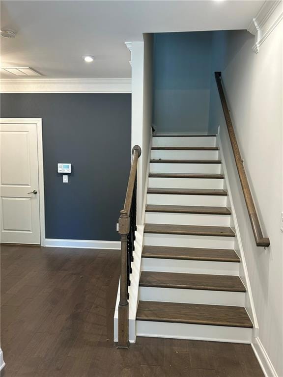 Stairs with baseboards, crown molding, wood finish