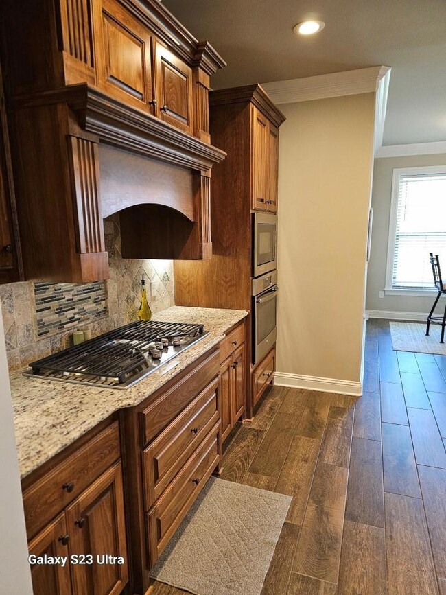 Kitchen with light stone countertops, ornamental m