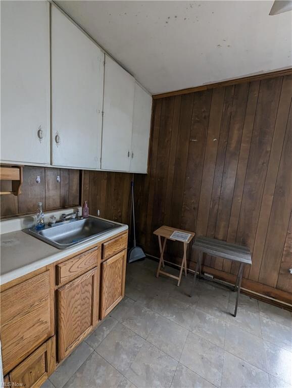 Kitchen featuring wooden walls and tile flooring