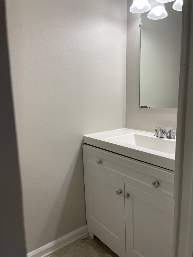 Bathroom featuring vanity and baseboards