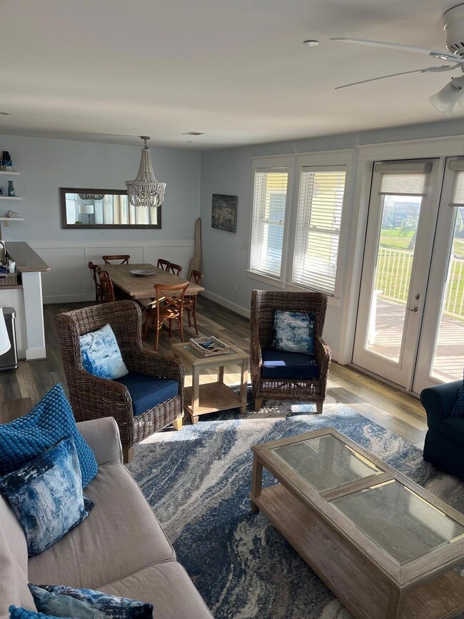 Living room featuring ceiling fan, wood-type floor