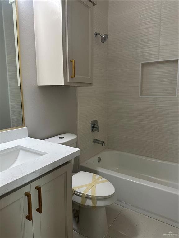 Bathroom with toilet, tile patterned floors, vanity, and tub / shower combination