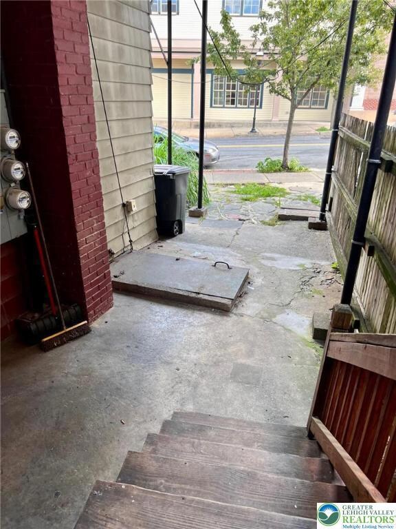 cute patio area by the sidewalk leads to your door
