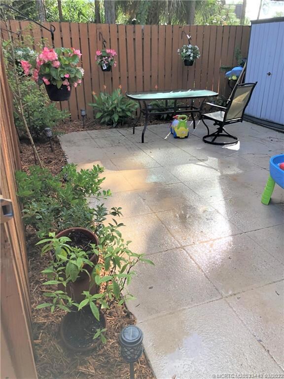 Patio with storage shed and planting beds