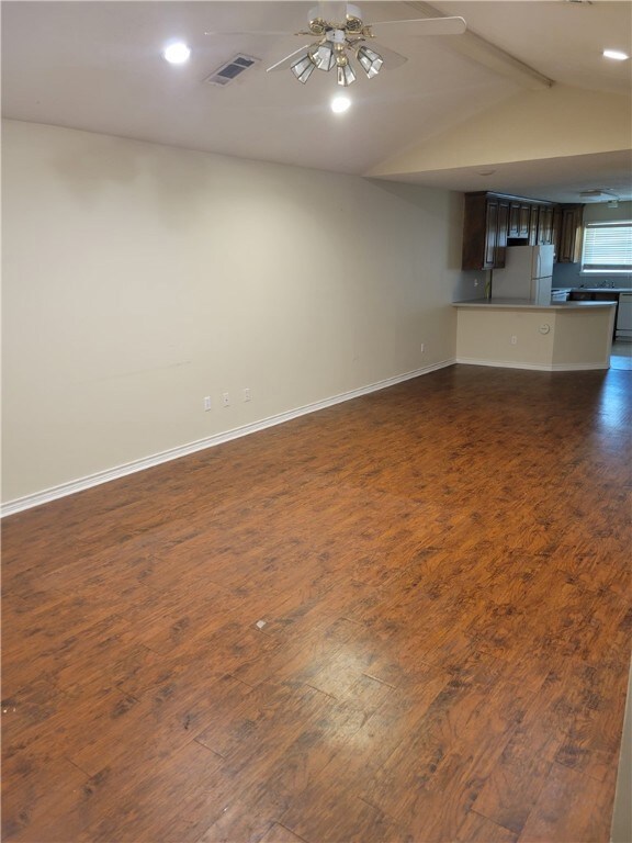 Unfurnished living room with dark wood finished fl