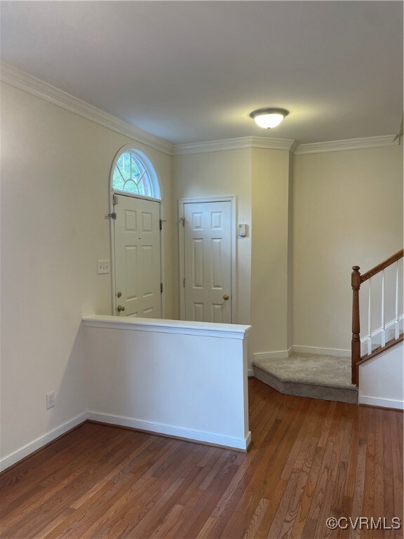 Entrance foyer featuring crown molding and hardwoo