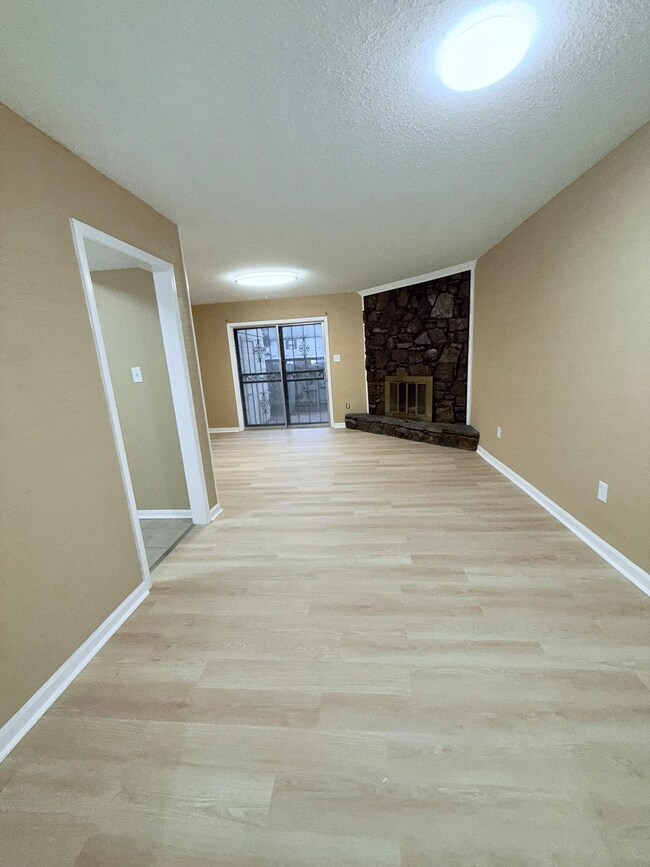Unfurnished living room with baseboards, a texture