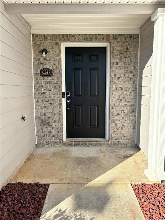 Entrance to property with stone siding